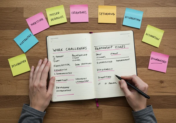 Person writing down real-life ADHD symptom examples.